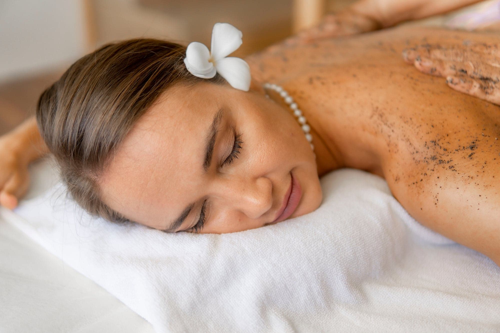 A guest resting during a body scrub at Lavella Spa